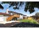 Well-maintained backyard with a deck, manicured lawn, stone patio and wood privacy fence at 10932 W 107Th Ave, Broomfield, CO 80021