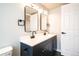 Bathroom with black fixtures and double sinks with an abundance of counter space at 10932 W 107Th Ave, Broomfield, CO 80021