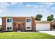 Beautiful two-story brick home with an attached two-car garage and manicured front lawn at 10932 W 107Th Ave, Broomfield, CO 80021