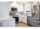Updated kitchen with stainless steel appliances, bright white cabinetry, and modern fixtures and finishes at 10932 W 107Th Ave, Broomfield, CO 80021