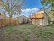 The backyard features a fence, grass, and an accessory structure with deck at 530 S Ames St, Lakewood, CO 80226