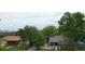 This exterior shows a quaint home with mature trees providing shade and greenery at 530 S Ames St, Lakewood, CO 80226