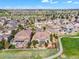 Aerial view of a neighborhood featuring well-maintained homes, lush greenery, and a nearby golf course at 6999 S Tempe Ct, Aurora, CO 80016