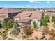 Aerial view of a home with a large patio, stone fire pit, and beautifully landscaped yard at 6999 S Tempe Ct, Aurora, CO 80016