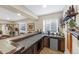 Basement bar area with granite countertops, wooden cabinets and a mini fridge, perfect for entertaining guests at 6999 S Tempe Ct, Aurora, CO 80016
