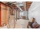 Unfinished basement providing potential for custom design with visible pipes, water heater and an open layout at 6999 S Tempe Ct, Aurora, CO 80016
