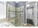 Contemporary bathroom featuring a glass shower, tile surround, and a view into the closet area at 6999 S Tempe Ct, Aurora, CO 80016