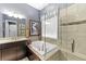 Elegant bathroom with a soaking tub, tiled shower, and stylish fixtures provides a relaxing retreat at 6999 S Tempe Ct, Aurora, CO 80016