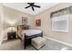 Comfortable bedroom features a ceiling fan, an upholstered ottoman, and a decorative headboard at 6999 S Tempe Ct, Aurora, CO 80016