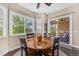 Bright dining area features a wooden table set and views of the outdoor patio, perfect for Gathering meals at 6999 S Tempe Ct, Aurora, CO 80016