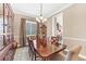 Elegant dining room with a large wooden table, chandelier, and classic decor for formal gatherings at 6999 S Tempe Ct, Aurora, CO 80016