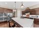 Gourmet kitchen with stainless steel appliances, a center island, and dark wood accents at 6999 S Tempe Ct, Aurora, CO 80016