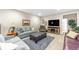 Finished basement featuring a cozy living room area with comfortable seating and modern entertainment center at 6999 S Tempe Ct, Aurora, CO 80016