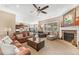 Bright living room with fireplace, large windows, and seamless flow into the adjacent kitchen at 6999 S Tempe Ct, Aurora, CO 80016