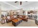 Spacious living room featuring two leather sofas and an open floor plan to the kitchen at 6999 S Tempe Ct, Aurora, CO 80016