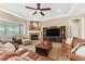 Cozy living room featuring a fireplace, comfortable seating, and neutral décor at 6999 S Tempe Ct, Aurora, CO 80016