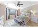 Luxurious main bedroom features a bay window, soft carpet, and a comfortable seating area, creating a private retreat at 6999 S Tempe Ct, Aurora, CO 80016