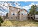 Well-maintained backyard with lush grass, mature trees, and a private deck at 7099 Cerney Cir, Castle Pines, CO 80108