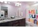 Stylish bathroom with double vanity, granite countertops, and colorful shower curtain at 7099 Cerney Cir, Castle Pines, CO 80108