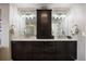 Double vanity with granite countertop and dark wood cabinetry at 7099 Cerney Cir, Castle Pines, CO 80108