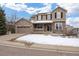 Charming two-story home featuring stone accents, a covered porch, and a well-manicured front lawn at 7099 Cerney Cir, Castle Pines, CO 80108