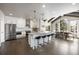 Bright kitchen with white cabinets, stainless steel appliances, and an island with bar stool seating at 7099 Cerney Cir, Castle Pines, CO 80108