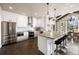 Spacious kitchen features stainless steel appliances and a large island with seating at 7099 Cerney Cir, Castle Pines, CO 80108