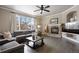 Inviting living room showcases a stone fireplace with mantle, dark hardwood floors, and a comfortable gray sofa at 7099 Cerney Cir, Castle Pines, CO 80108