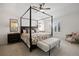 Spacious Primary bedroom featuring a beautiful four-poster bed and comfortable furnishings at 7099 Cerney Cir, Castle Pines, CO 80108