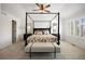 Spacious Primary bedroom featuring a beautiful four-poster bed and comfortable furnishings at 7099 Cerney Cir, Castle Pines, CO 80108