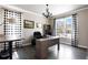 Well-lit home office with modern desk, built-ins, and a chandelier at 7099 Cerney Cir, Castle Pines, CO 80108