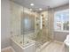Modern walk-in shower with glass enclosure and mosaic tile accent wall at 7099 Cerney Cir, Castle Pines, CO 80108