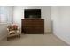 Bright sitting room area with dresser and window view at 7099 Cerney Cir, Castle Pines, CO 80108