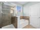 Bathroom featuring a glass enclosed shower and soaking tub with tiled walls at 9039 E Panorama Cir # C201, Englewood, CO 80112
