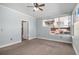 Light-filled bedroom features carpet, neutral paint, trim detail and a large window at 9039 E Panorama Cir # C201, Englewood, CO 80112