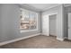 Bedroom with carpet, neutral paint and trim, a large window with blinds and closet at 9039 E Panorama Cir # C201, Englewood, CO 80112