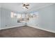 Bedroom with carpet flooring, ceiling fan, and large window providing natural light at 9039 E Panorama Cir # C201, Englewood, CO 80112