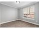 Bedroom with carpet, neutral paint and trim, a large window with blinds at 9039 E Panorama Cir # C201, Englewood, CO 80112