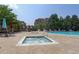 Close up on a bubbling hot tub adjacent to the pool with tables and chairs nearby at 9039 E Panorama Cir # C201, Englewood, CO 80112