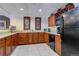 Common kitchen with granite countertops and black appliances at 9039 E Panorama Cir # C201, Englewood, CO 80112