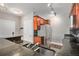 Kitchen featuring a breakfast bar and stainless steel appliances, with granite countertops and wooden cabinets at 9039 E Panorama Cir # C201, Englewood, CO 80112