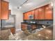 Kitchen features stainless steel appliances, granite countertops, wood cabinets, and modern track lighting at 9039 E Panorama Cir # C201, Englewood, CO 80112