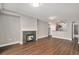 Open-concept living room with hardwood floors, a fireplace, and an archway leading into the kitchen at 9039 E Panorama Cir # C201, Englewood, CO 80112
