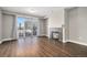 Bright living room features a cozy fireplace, hardwood floors, and a sliding glass door to a balcony at 9039 E Panorama Cir # C201, Englewood, CO 80112