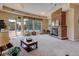 Spacious lounge area featuring a brick fireplace, comfortable seating, and views of the pool at 9039 E Panorama Cir # C201, Englewood, CO 80112