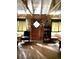 Cozy living room featuring wood walls, bright windows, seating and warm ambiance at 10504 Jackson Creek Rd, Sedalia, CO 80135