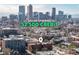 An aerial view of a building in a vibrant city, showcasing a $2500 credit for the buyer at closing at 1475 N Humboldt St # 22, Denver, CO 80218