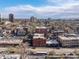 Aerial view of Denver apartment building with tree-lined neighborhood and city skyline at 1475 N Humboldt St # 22, Denver, CO 80218
