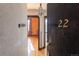 Front door of apartment number 22, with a glimpse inside revealing hardwood floors and brick wall at 1475 N Humboldt St # 22, Denver, CO 80218