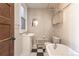 Vintage-style bathroom features a clawfoot tub and black-and-white checkered floors at 1475 N Humboldt St # 22, Denver, CO 80218